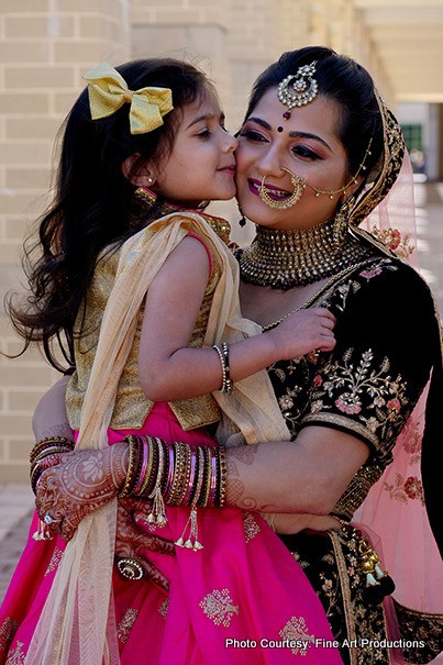 Cute Girl Kissing Indian Bride