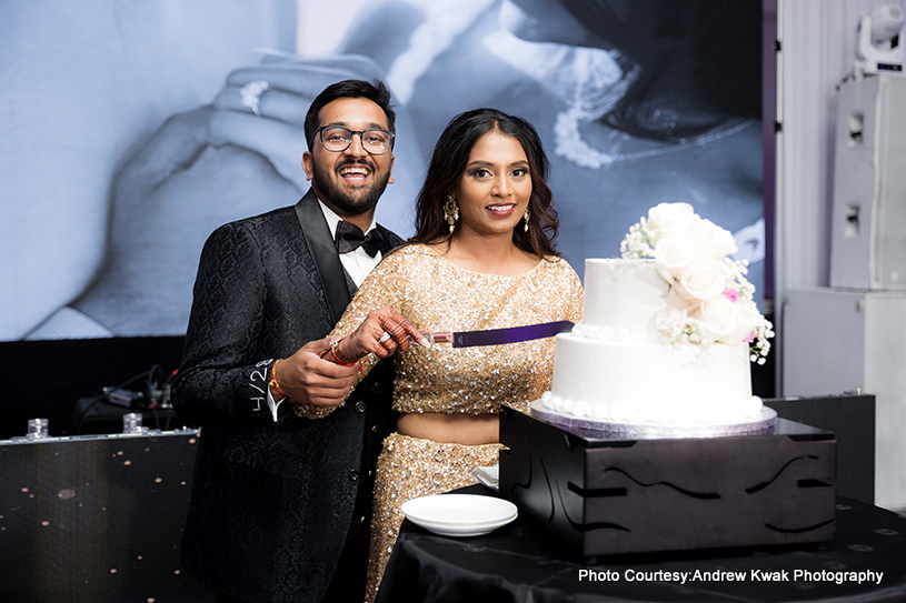 Indian wedding couple cuts wedding cake