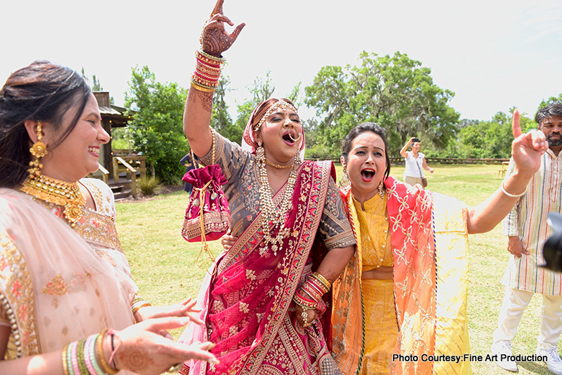 Indian bride dancing with relatives